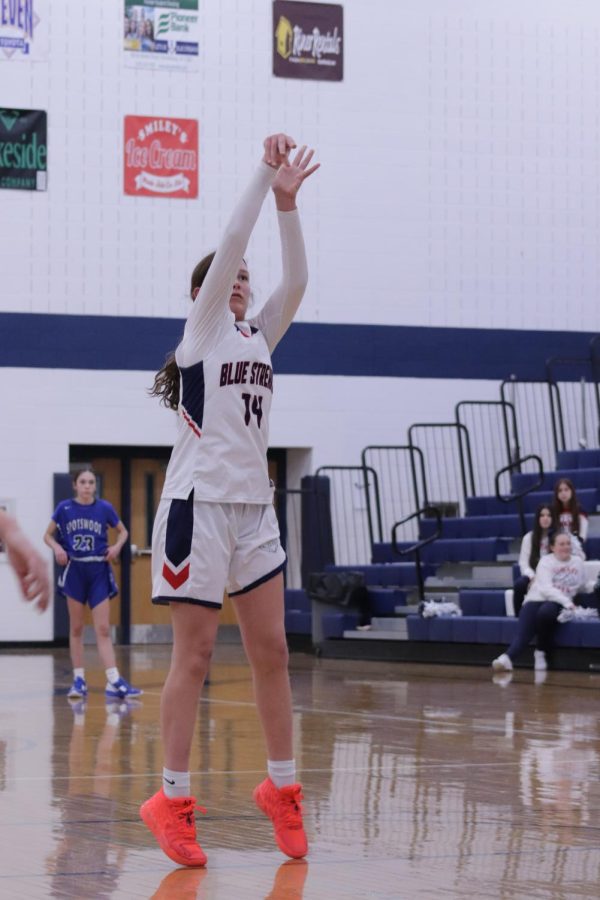 Eighth grade Addison Weakley shoots a basket. 