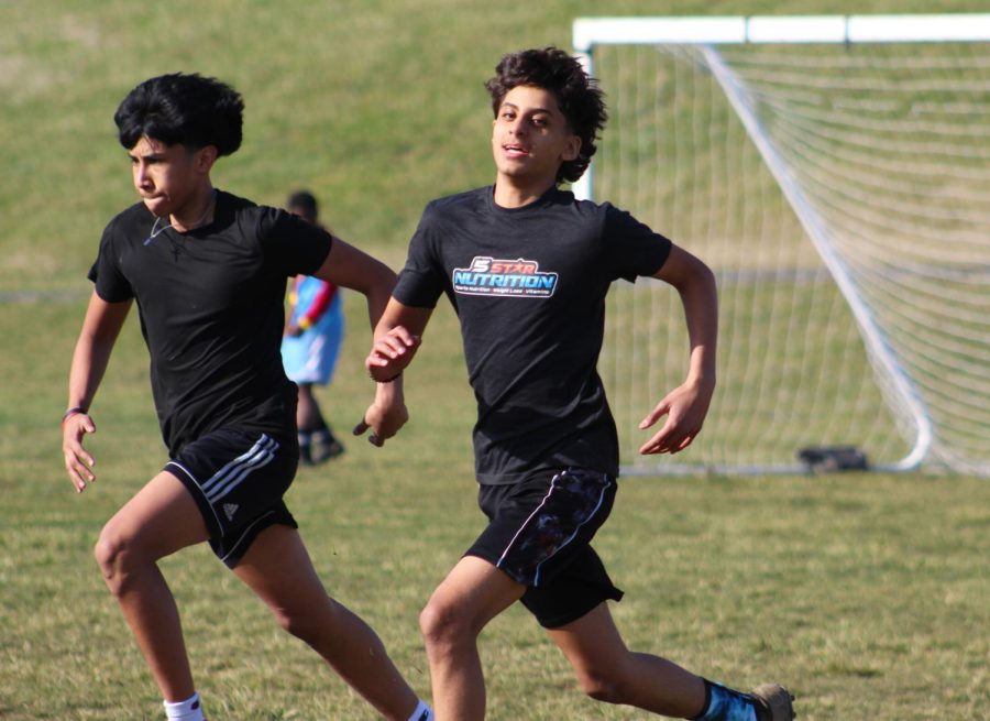 Sophomore Hugo Hernandez Perez and freshman Suhaib Alsaadun sprint during a running drill. 
