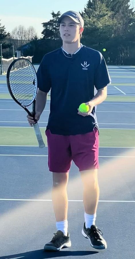 Junior Julien Steins looks to his coach for advice during his doubles match against Staunton.