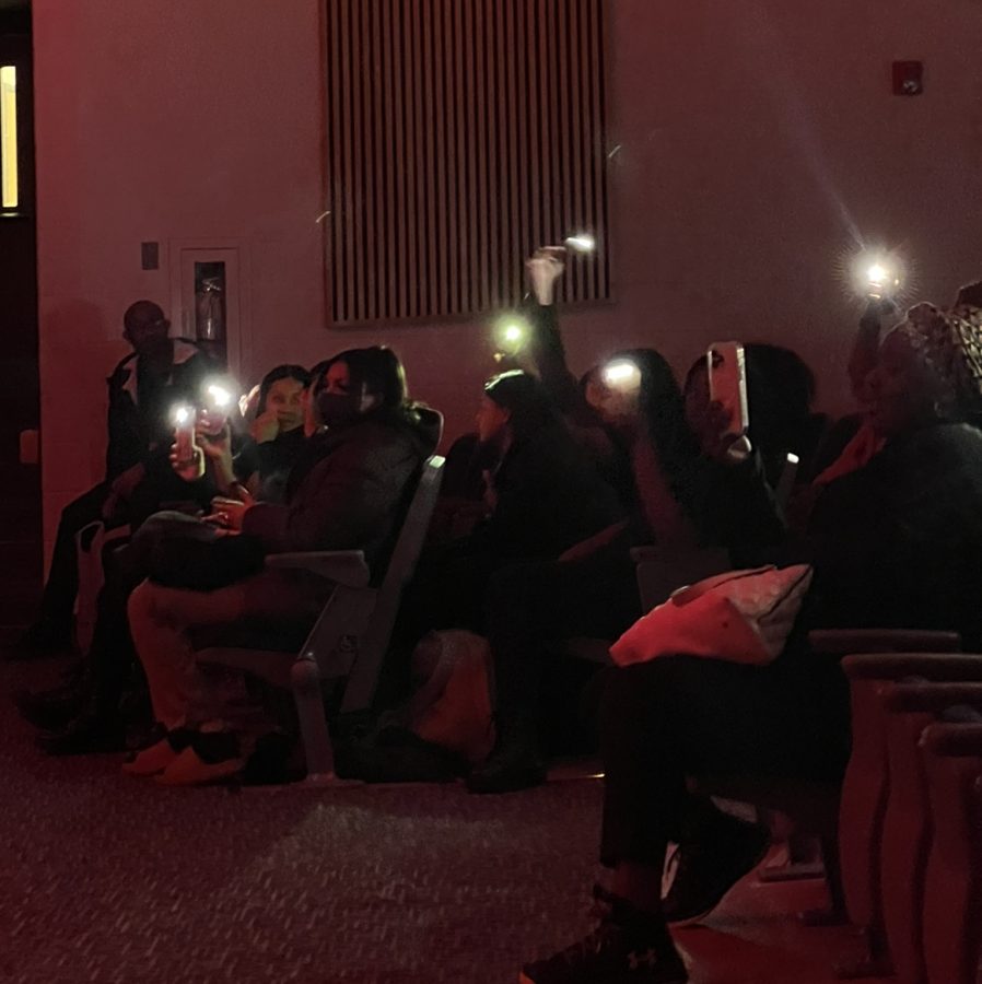 The Skyline step team holding their phones with flash while Nina Alabanza sings killing you softly by Fugees.