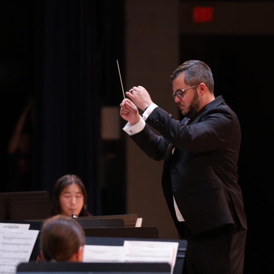 Band director Daniel Upton conducts the symphonic band during the Prism concert. 