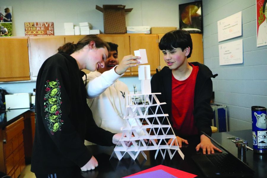 Sophomores Alex Bingay, Theo Thompson and Giovanni Sanchez-Garcia top of their second place paper made tower.
