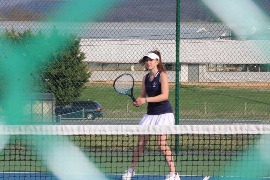 During her singles match, junior Caryanne Shaw prepares to receive the ball.