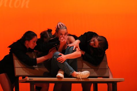 Junior Sophia Pimentel Yoder gets surrounded by fellow dancers in a shared piece with sophomore Aiyana Thornton called The Takeover. The surrounding dancers represent the fast fashion industry and the affect it has on not only the environment, but local thrift stores as well.