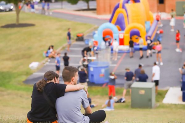 Junior Andrew Johnson and senior Rylee Stroop watches students participate in activities at the Back to School Bash.