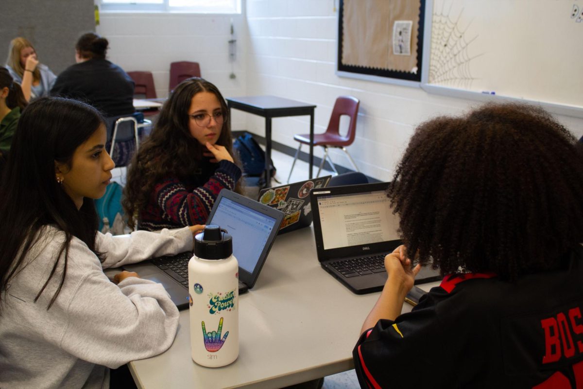 Aiyana Thornton and her group discussing through certain topics in the Debate.