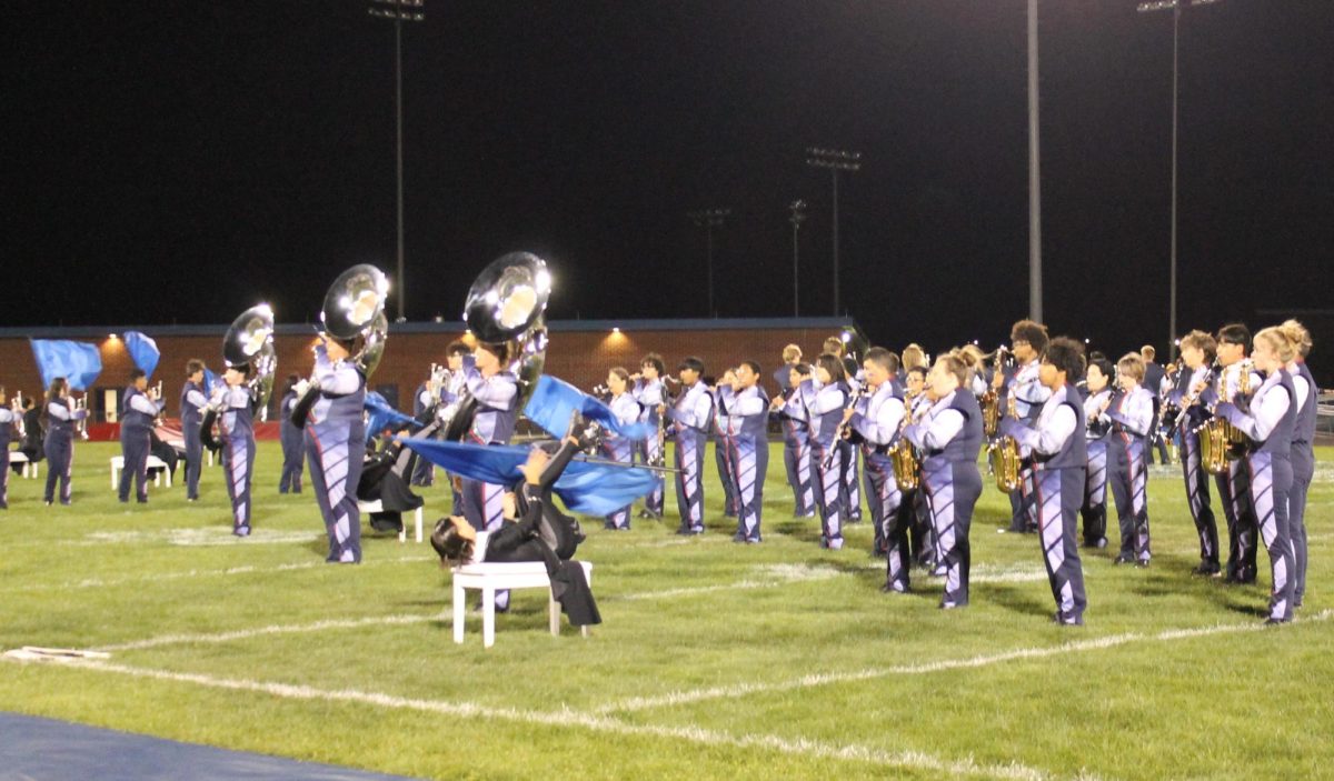 The HHS marching band and color guard perform at halftime, sept. 22. The color guard placed first in their last competition. “It was a little scary, but it was fun,” said Junior Davis Bert.
