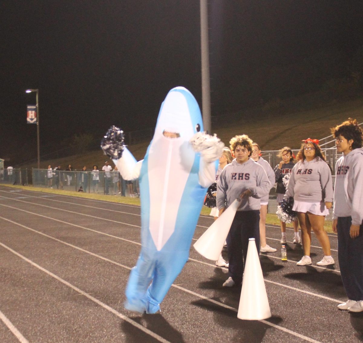 Freshman Addison Weakley runs around in a shark costume. There was about 20 students in the student section that night. “I did it to have fun and get people cheering,” Weakley said.
