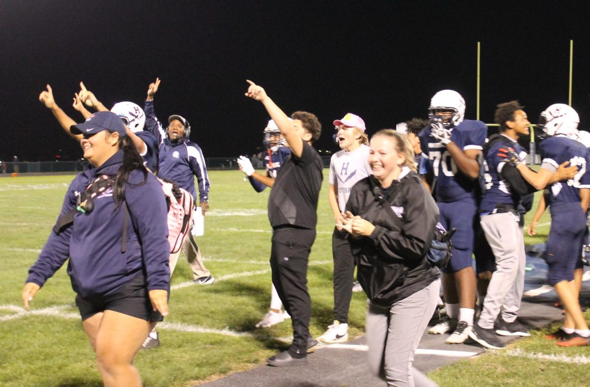 The sideline celebrates after their second touchdown Sept. 22. The team scored two total touchdowns. I had the chance to be on the sideline when the team got their first wild ,” Sophomore Selvin Claros said.

