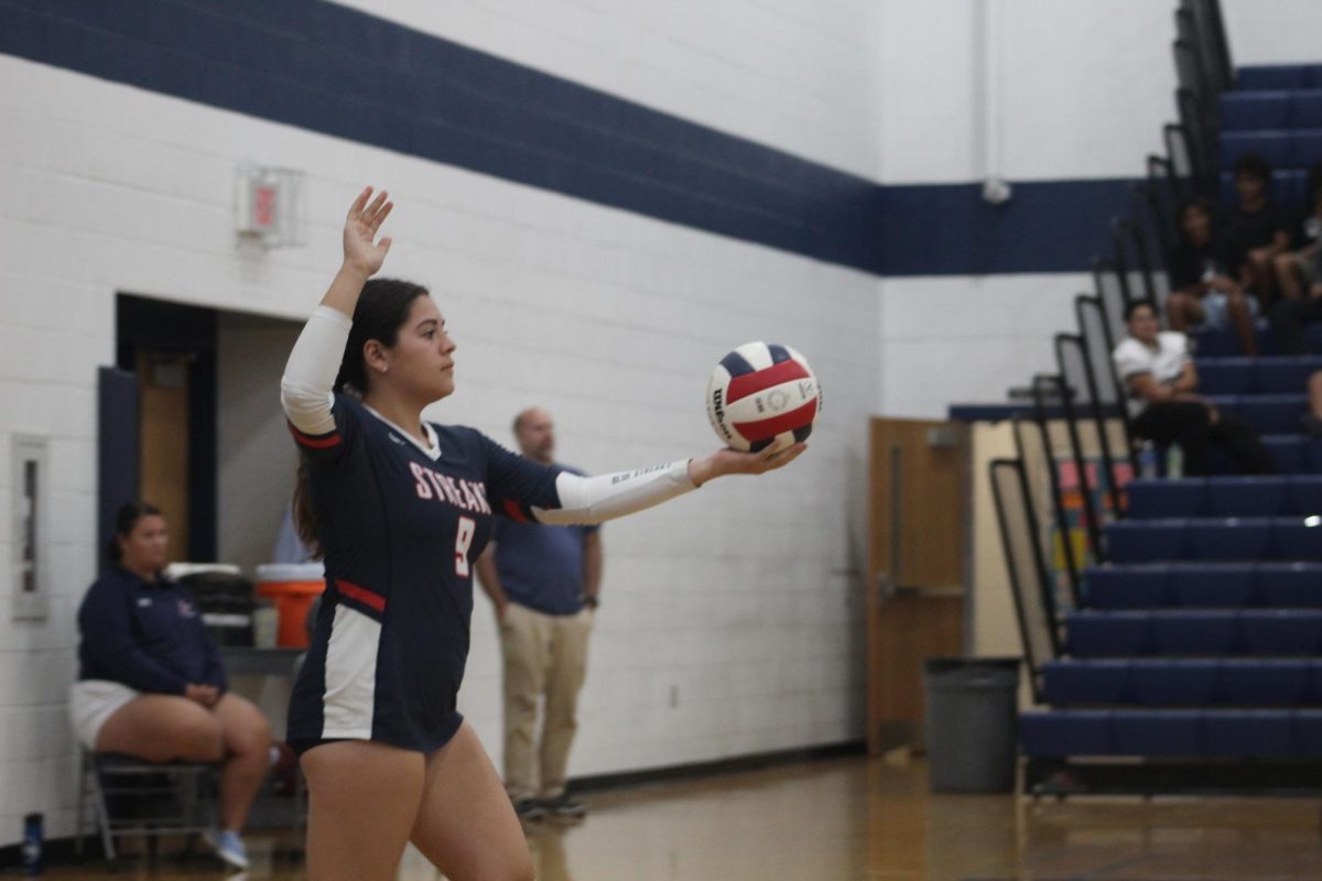  Senior Thaneisha Cedeno prepares to serve against Strasburg.