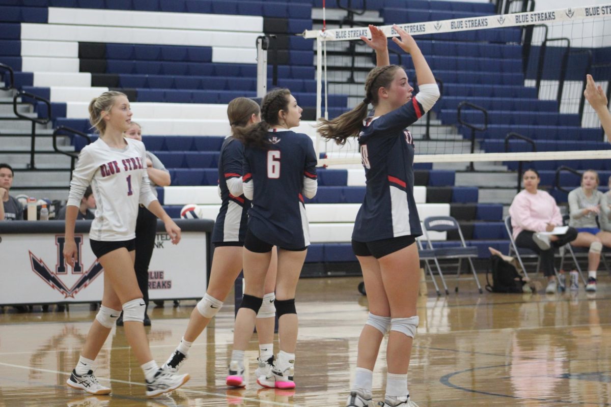 Junior Macy Waid signals a ball being out after a play.