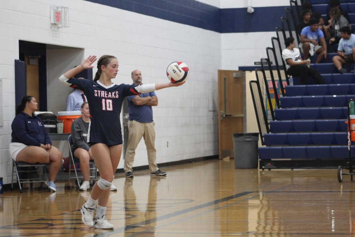 Junior Macy Waid prepares to serve.