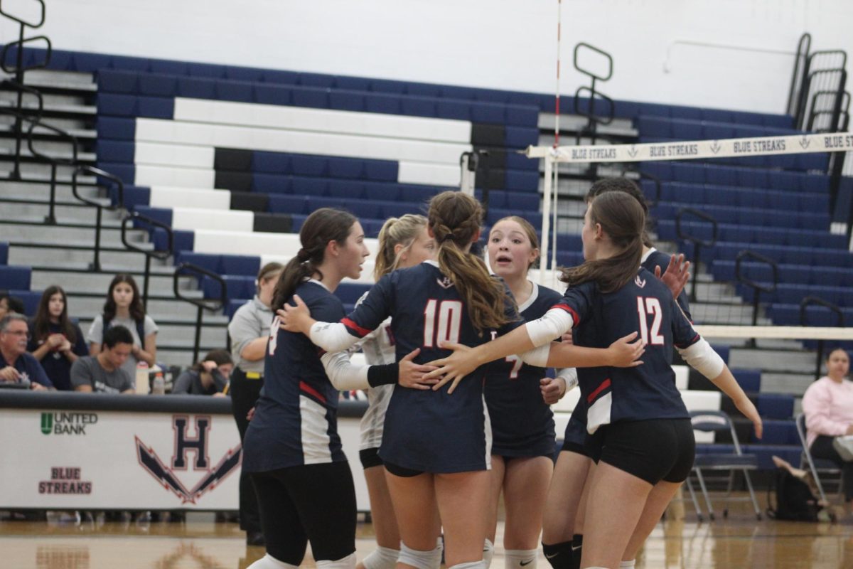  HHS volleyball encourages each other in their team huddle. 
