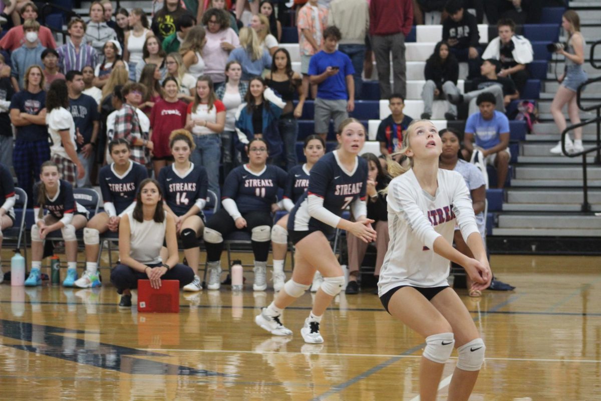 Junior Teagan Miller works to get the second ball after the setter is out.