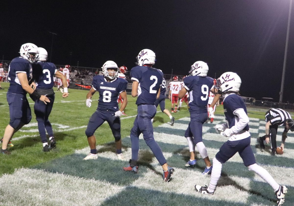 The varsity team celebrates a touchdown caught by  Deacon Smith during their game on Friday, Sept. 23, 2023.