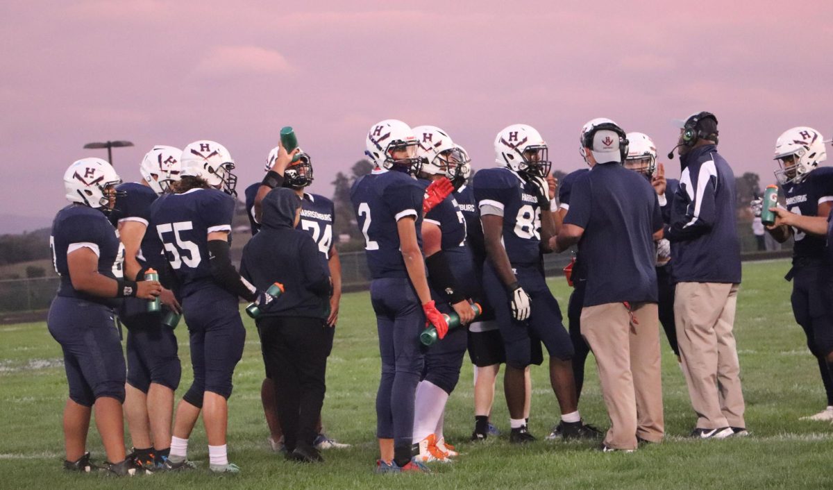 The varsity football team takes a time out to make a plan for the next play.