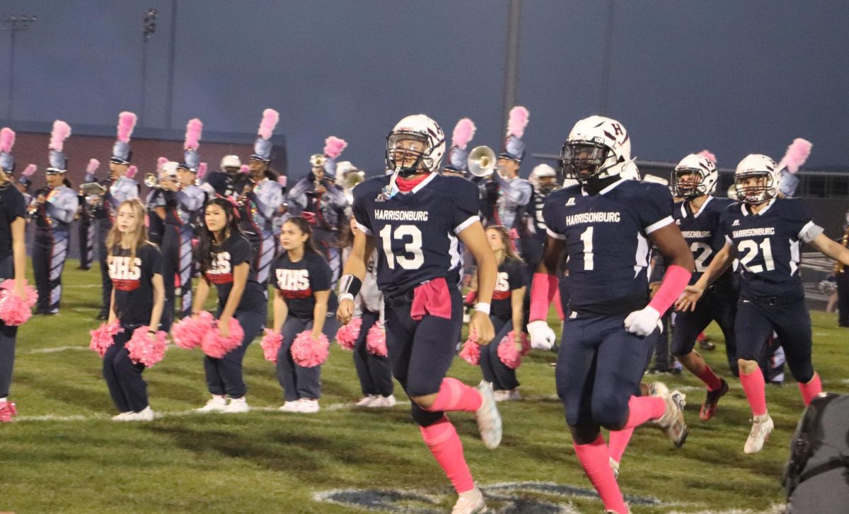 Freshman Yandel Robles runs out onto the field at the varsity football game on Friday, Oct. 13, 2023.