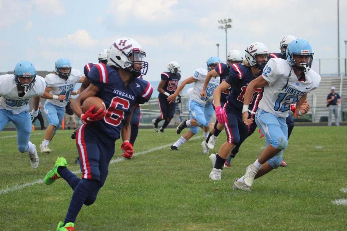 Senior Cadrian Rodgers-Davis runs down sideline after receiving.