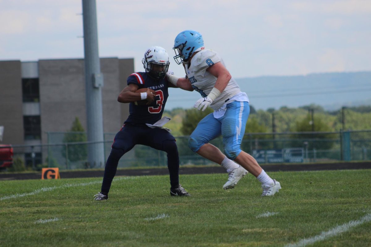 Senior Jathan Enlge blocks opponent from hitting.