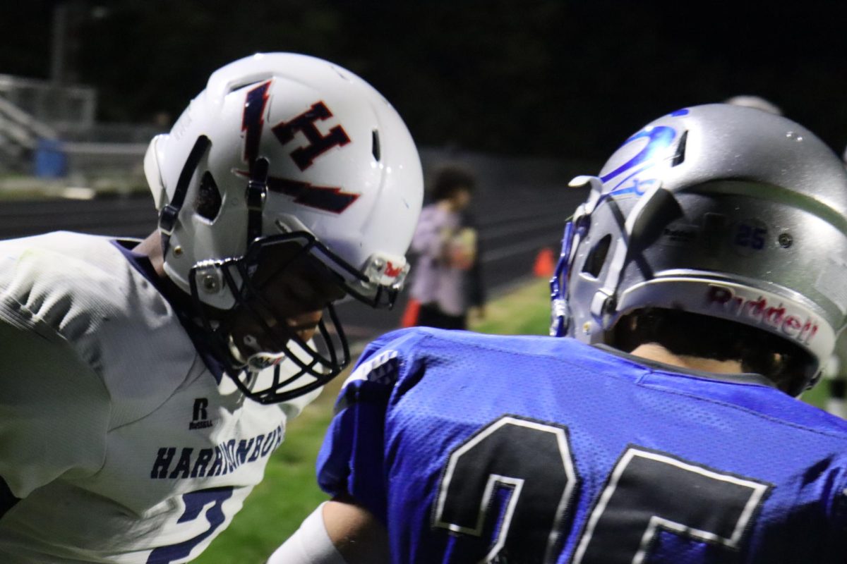 Freshman Ayden Groden talks to Spotswood player after a tackle.