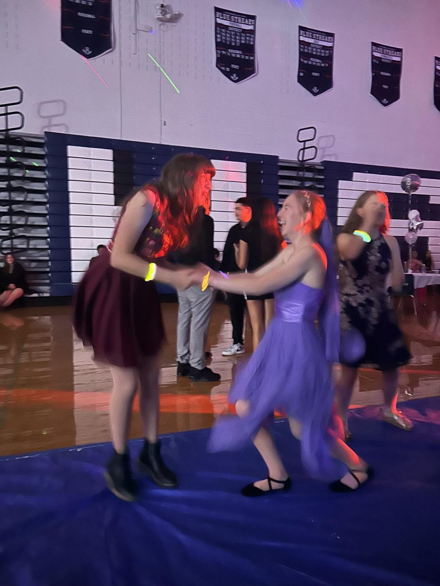 Sophomore Phoebe kauffman and Lilian Carpenter enjoy dancing to the songs played at homecoming.  
