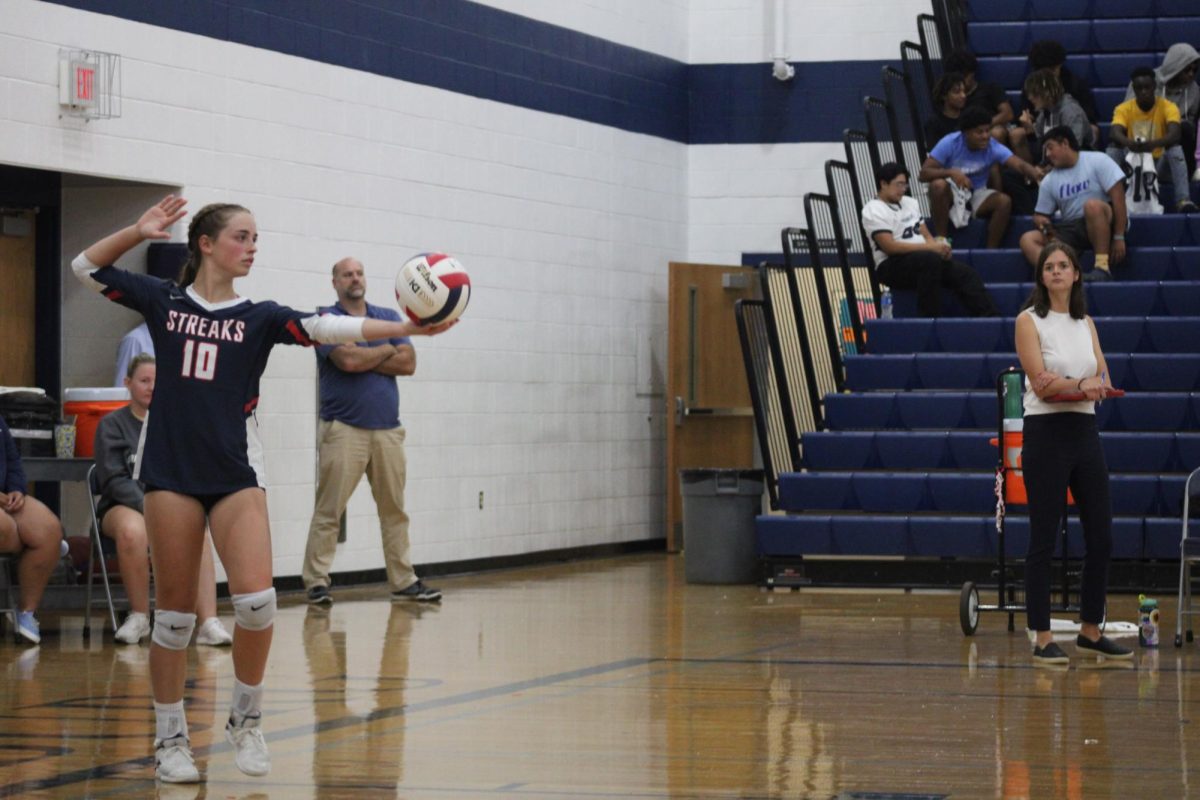 Junior Macy Waid doing her routine before serving the ball.