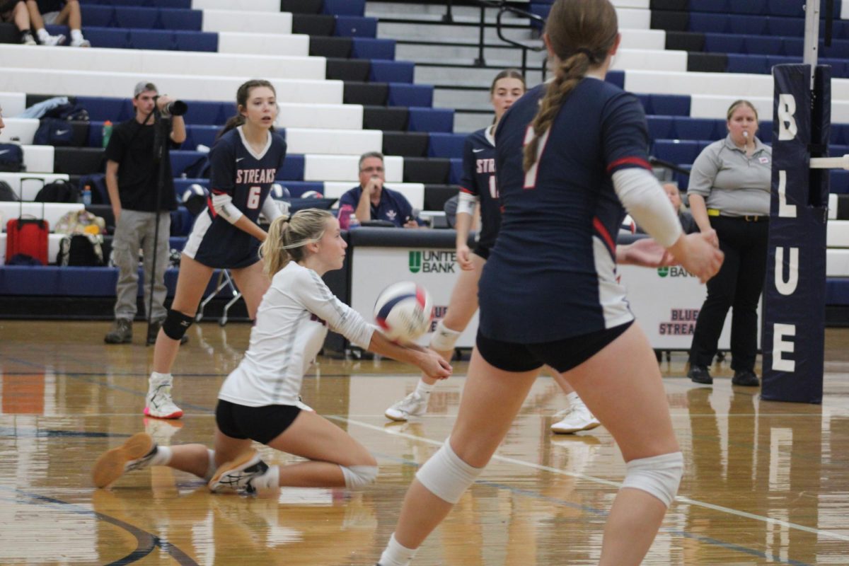 Junior Teagen Miller digs the ball from the opposing team.