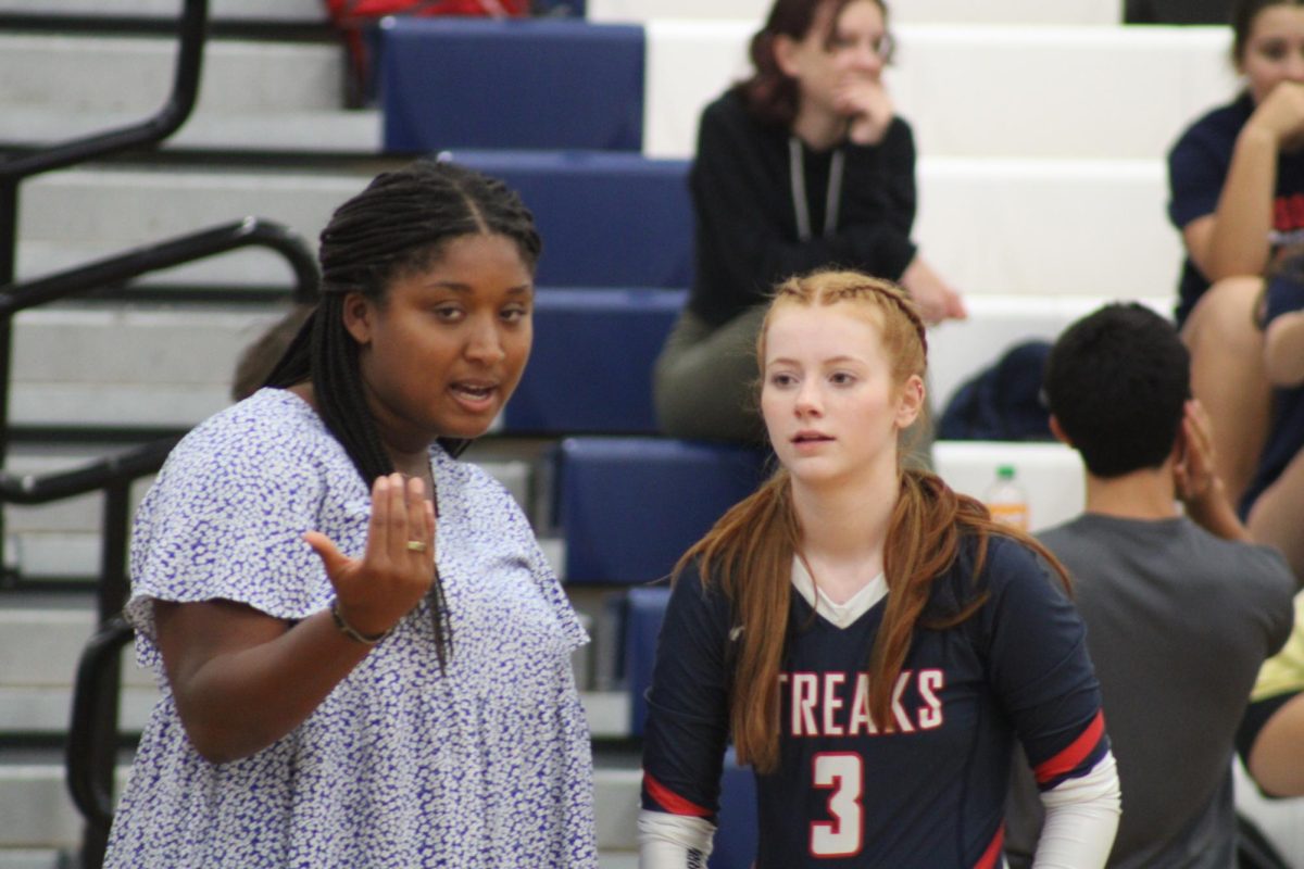 Coach Weeks talks to Junior Aubree Ringwald giving insight on her previous play.
