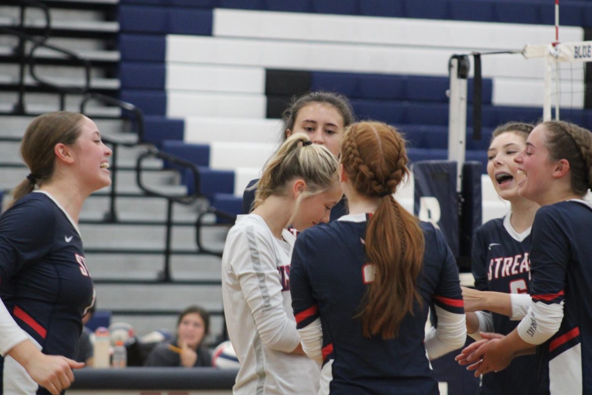 Group of players celebrating after earning a point on the opposing team.