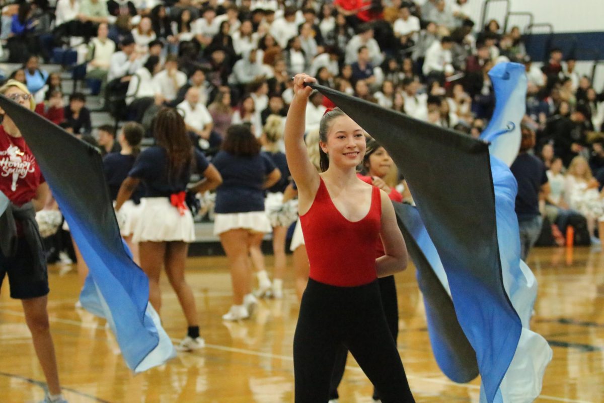 Sophomore Kate Bodle performs with the color guard 