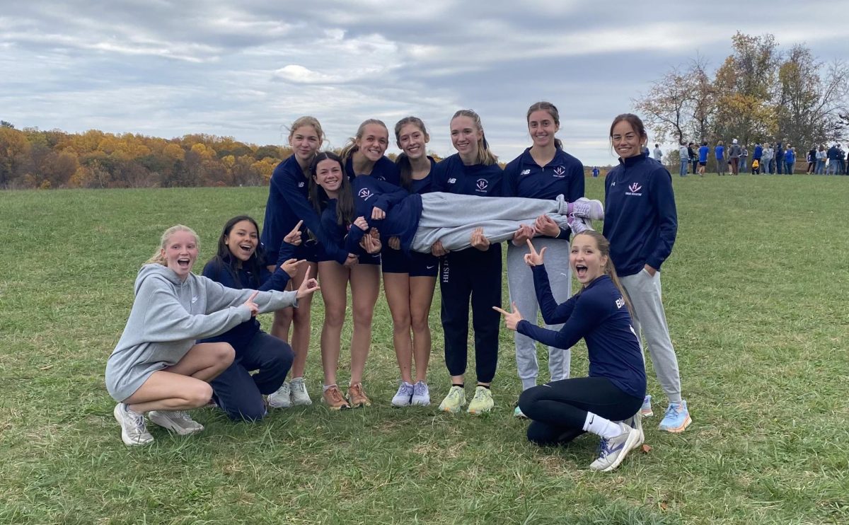 The girl cross country team poses for the camera together. (Photo Courtesy of Annie Poirot) 