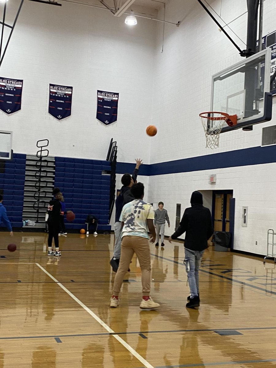 Students shoot for the hoop in gym class.