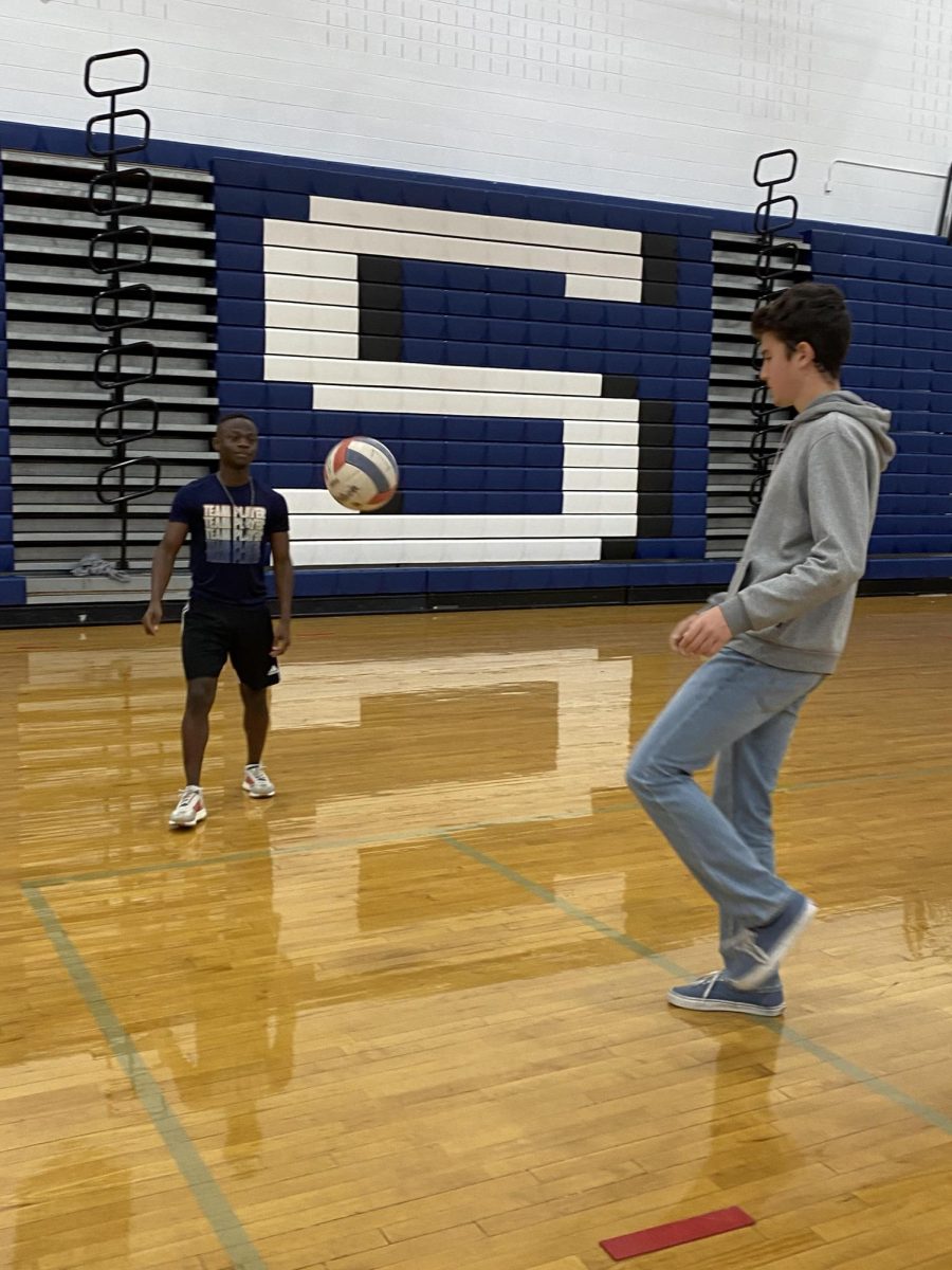 Freshman Ethan Jenkins passes the ball with a friend.