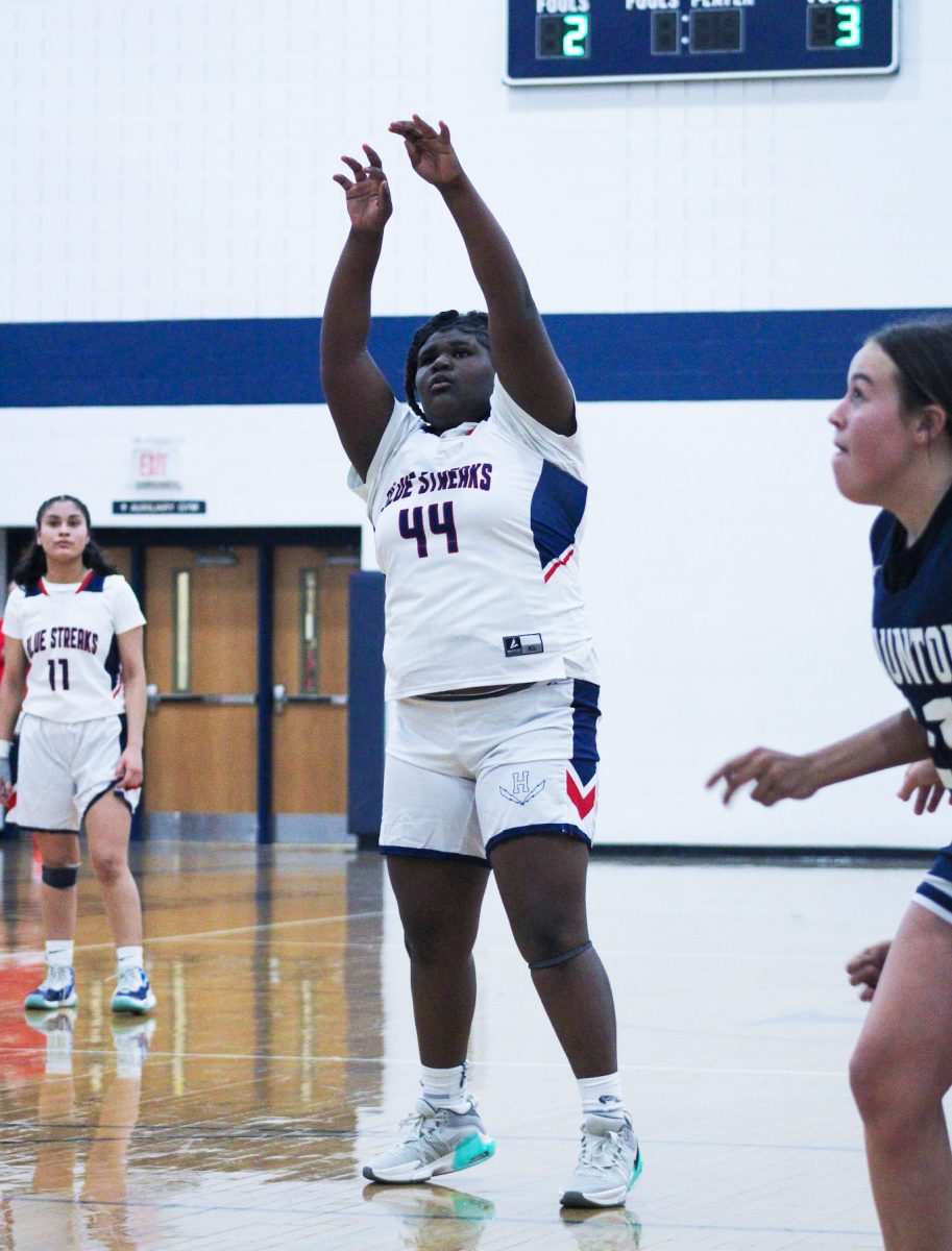 Freshman Emanuela Akotiate shoots a basket. 