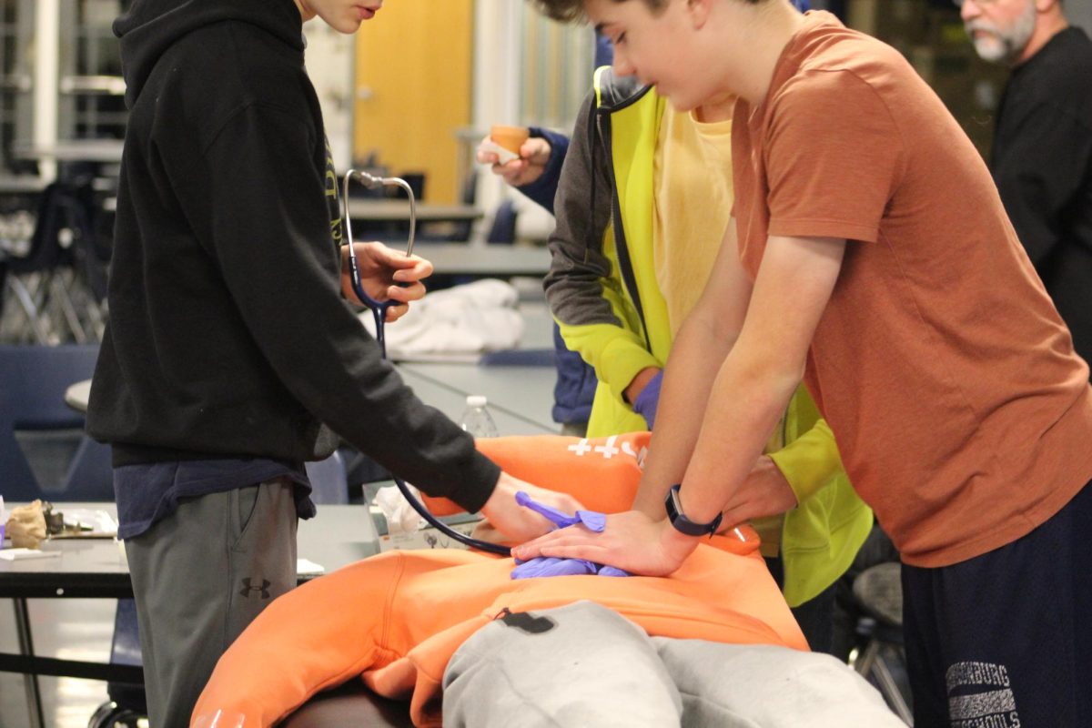 Students practice CPR at the medical station for STEM.