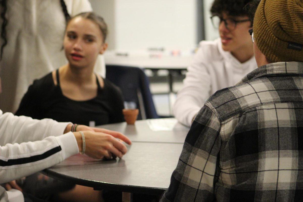 Students play black jack at the probability station at STEM night.