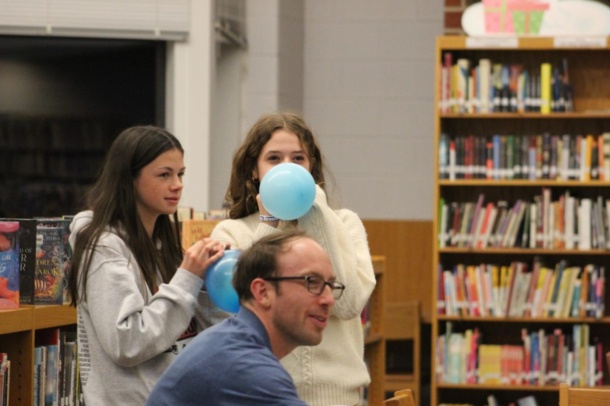 Students practice breathing with balloons at the mindfulness station.