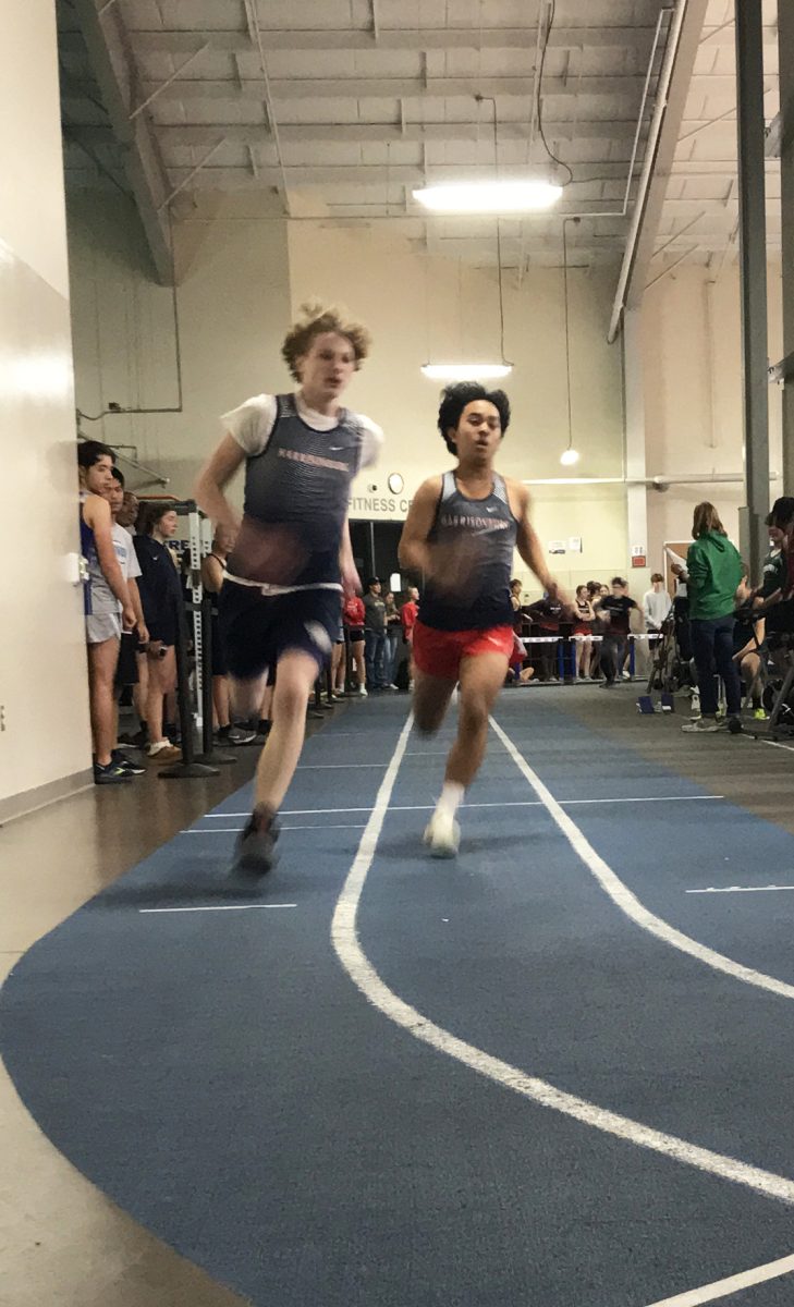 Freshman Mark Bishop and Sophomore Randell Eduard Joven running the 300 meter.
