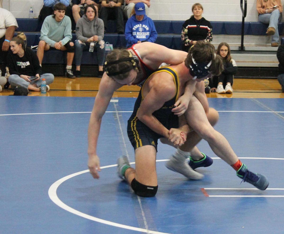 Senior Charlie Blair III scrambles with his opponent for the point from Fluvana.