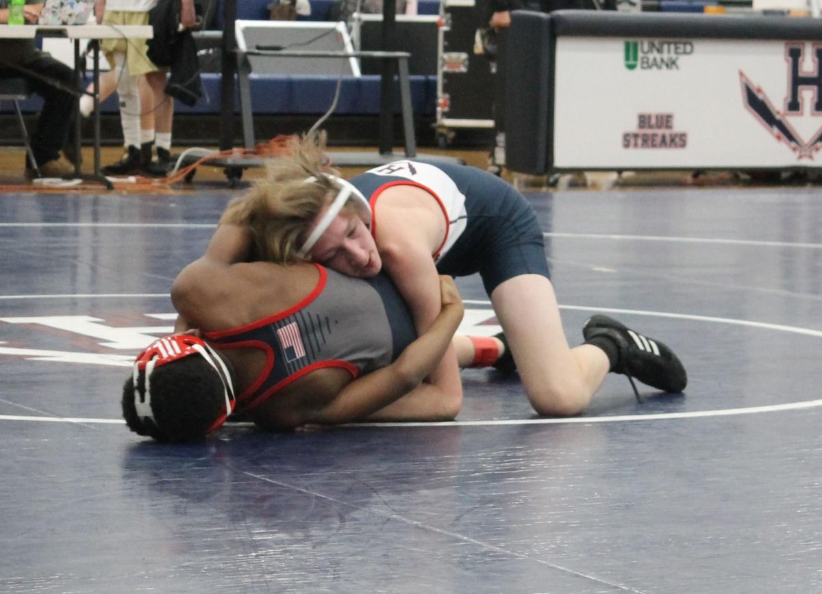 Freshman Matthew Bishop breaks down his opponent from JP Mccaskey at 106 lbs.
