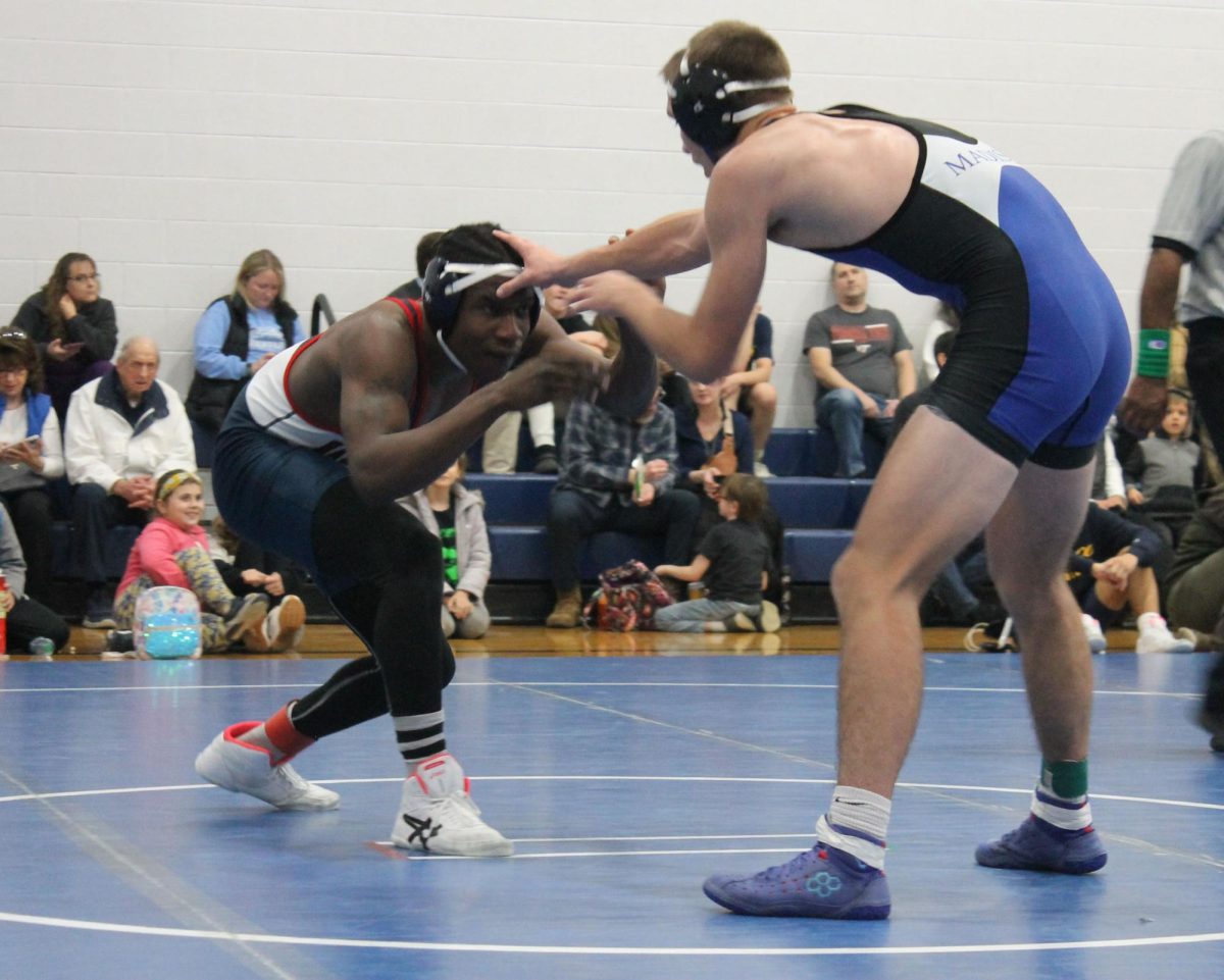 Junior Ariel Huseni blocks a grab from his opponent from Madison County.