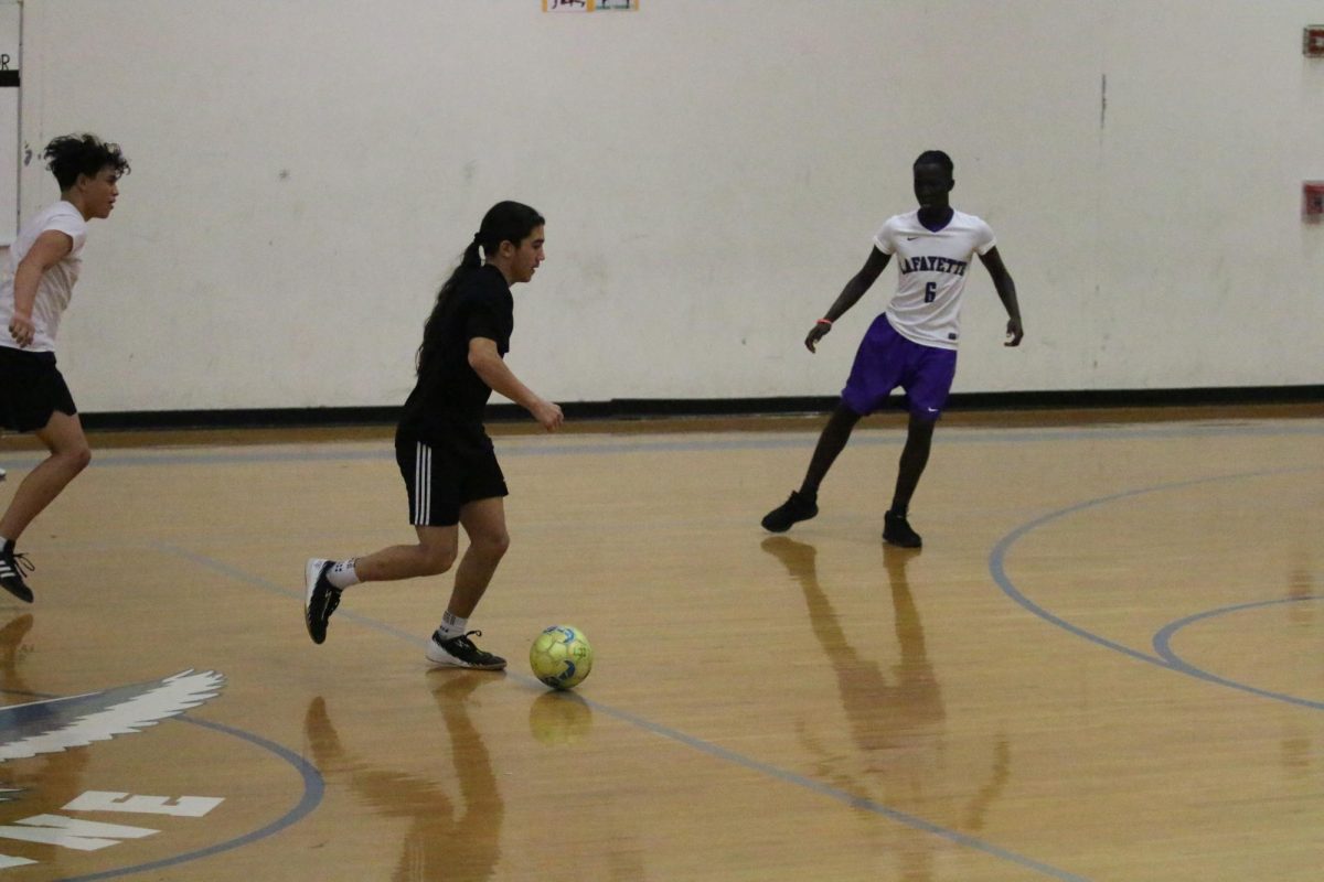 Senior Issac Cruz dribbles the ball down the court.