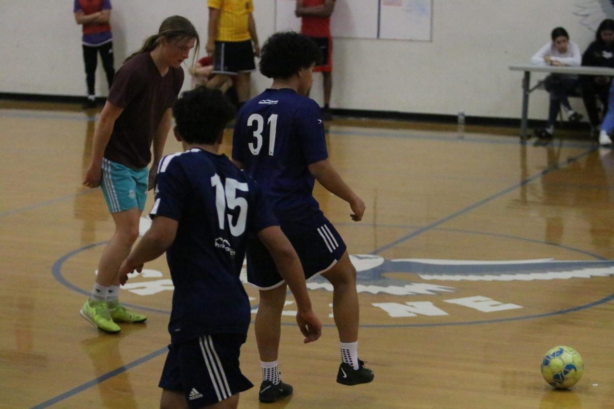 Sophomore Kaiden Velasquez rolls the ball to opponent Braeden Mcgrath.