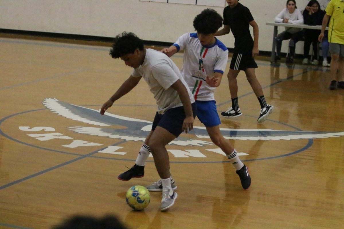 Senior Rodger Vasquez protects the ball from defender.