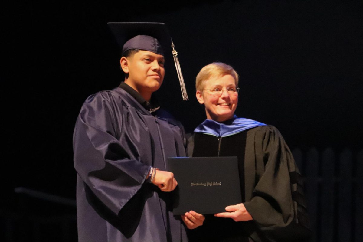 Dr. Hensley takes a picture with Sontay something while she hands him his diploma. Each one of these young men who are with us today have touched somebodys heart in a very special way. They have taught us more than they may ever know, Hensley said. 