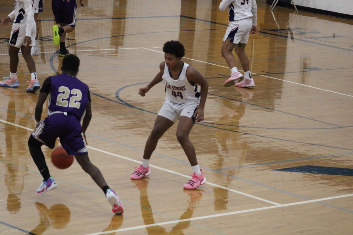 Sophomore Marshon Thomas closes in to narrow down opponent's shot.