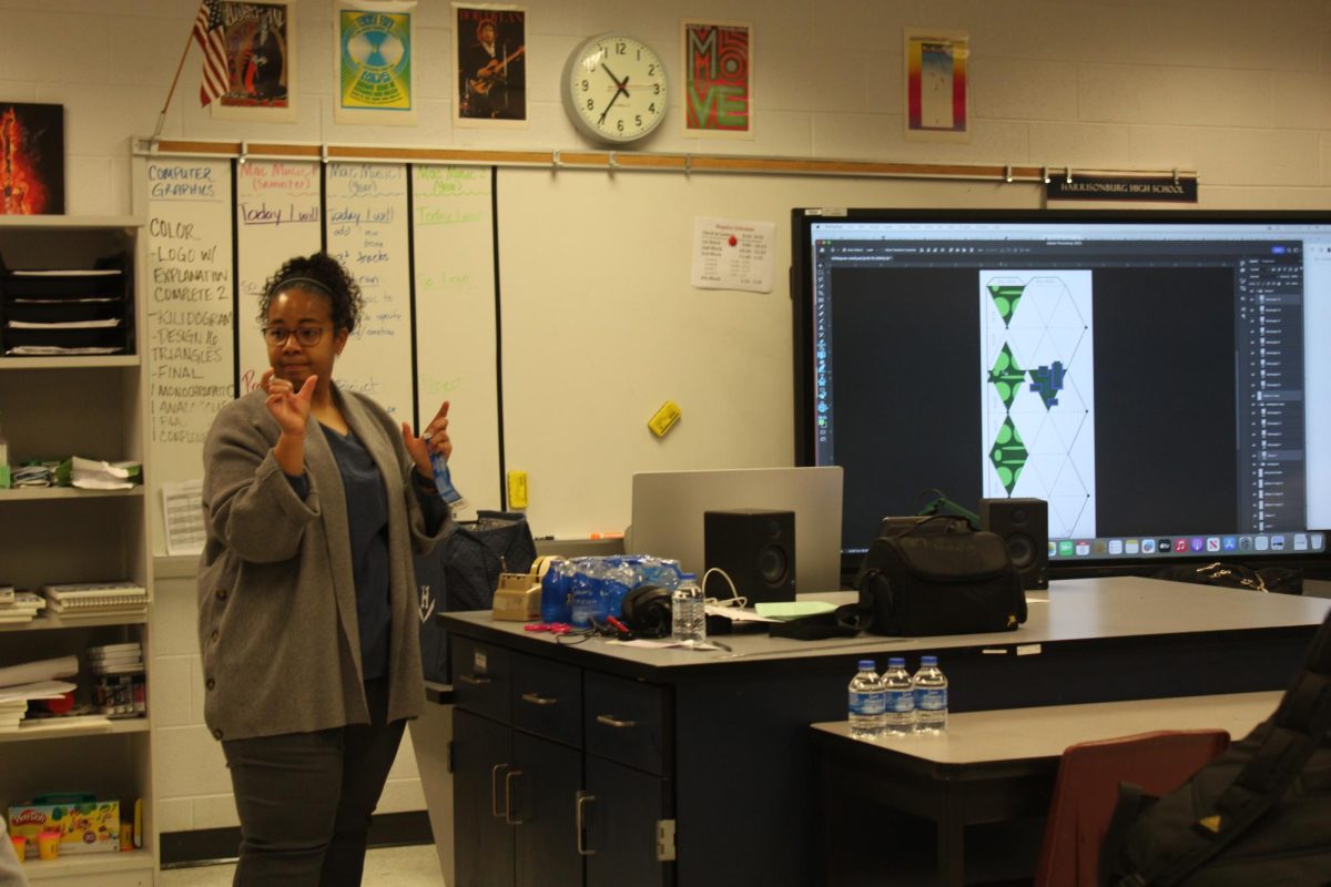 Teacher Jauan Brooks explains measurements for water bottle label.  