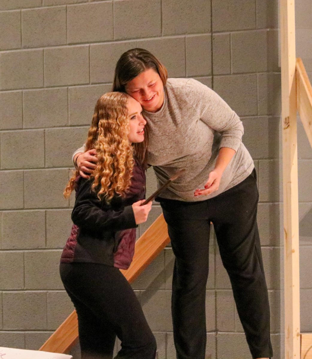 Freshman Leah Crawford hugs her cheer coach after receiving an award. 