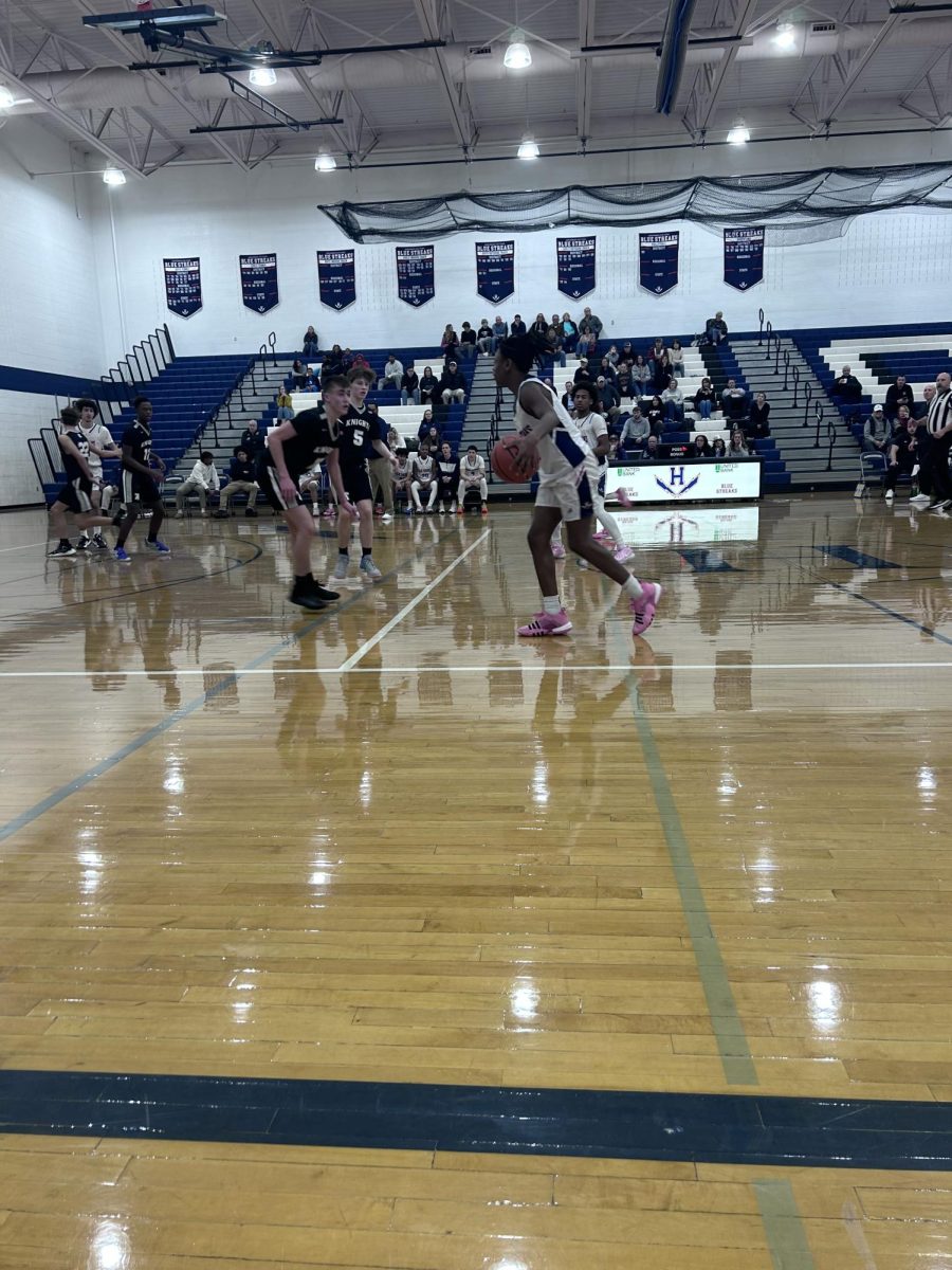 A player runs up the court before attempting to make a basket.