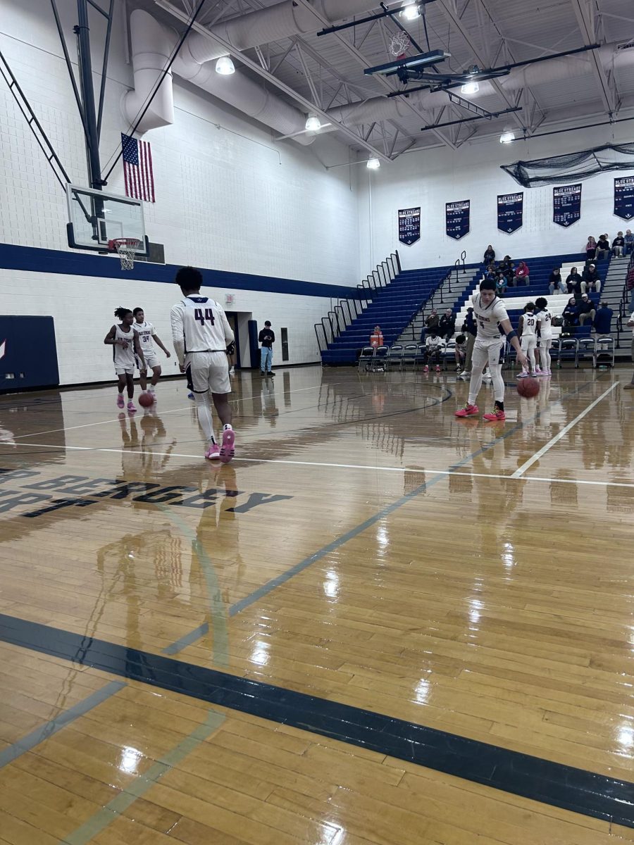 Yandel Robles warms up with a basketball during halftime.
